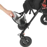 Parent folding a black baby stroller, showing the frame and small front wheel in the process of collapsing.