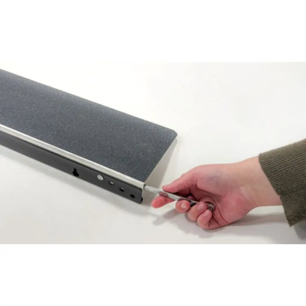 Doorline Variwedge 2 - O Neill Healthcare Person inserts a USB drive into a long, fabric-covered media bar on a white table.