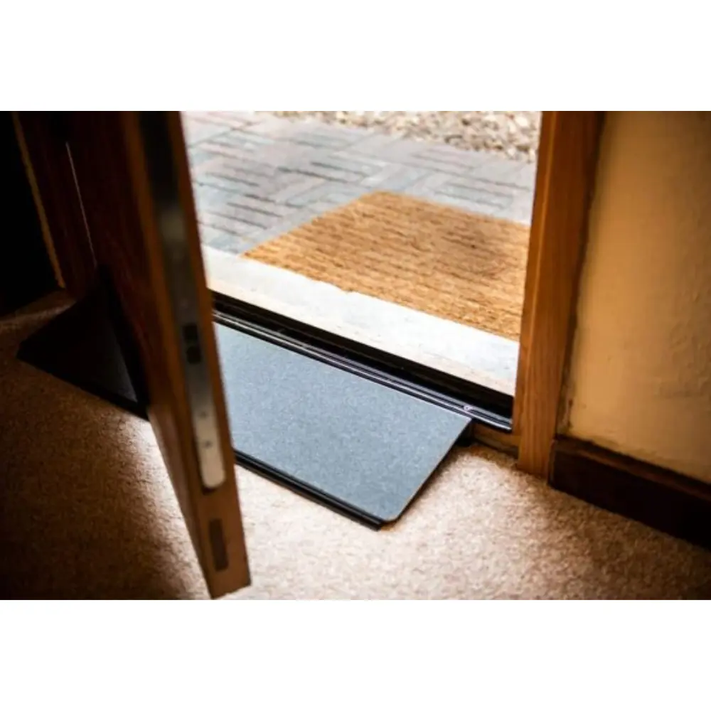 Doorline Variwedge 3 - O Neill Healthcare Blue portable ramp placed at a doorway threshold, bridging indoors to outdoors.